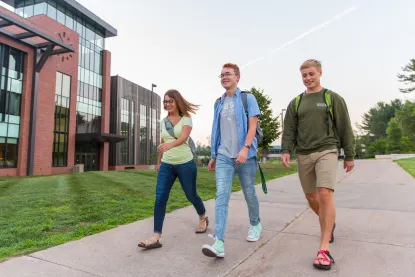 Three students walking on NMU's academic mall