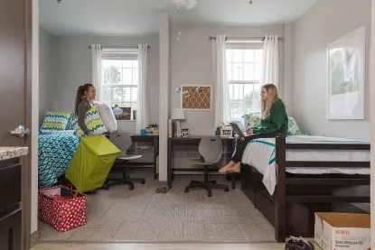 Two female students in a shared bedroom suite