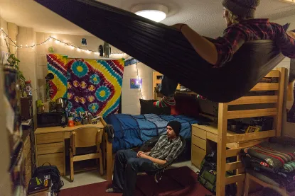 Two male students in a residence hall room