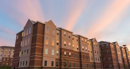 The Woods residence hall complex at sunset